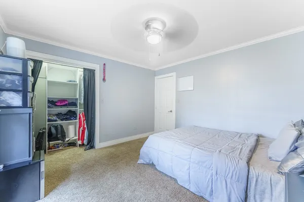 a bedroom with a bed and a walk in closet