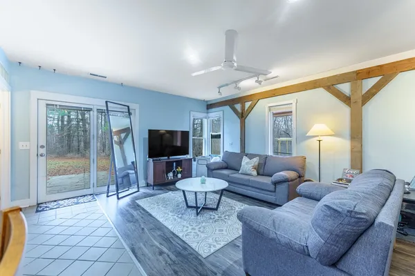 a living room with furniture and a flat screen tv