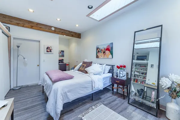 a bedroom with a bed and a bookshelf
