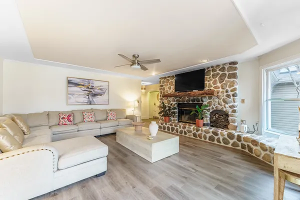 a living room with fireplace furniture and a flat screen tv