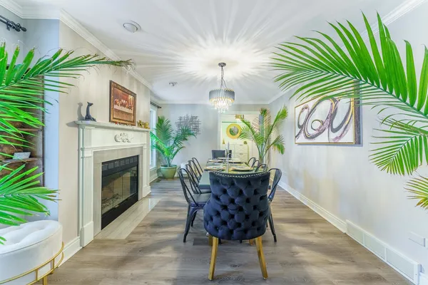 a dining room with furniture a fireplace and a potted plant