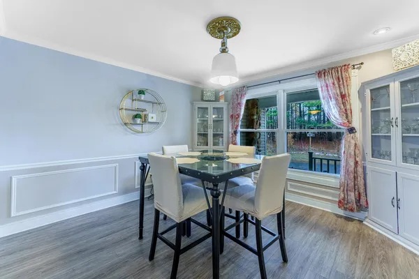 a view of a dining room with furniture wooden floor and chandelier