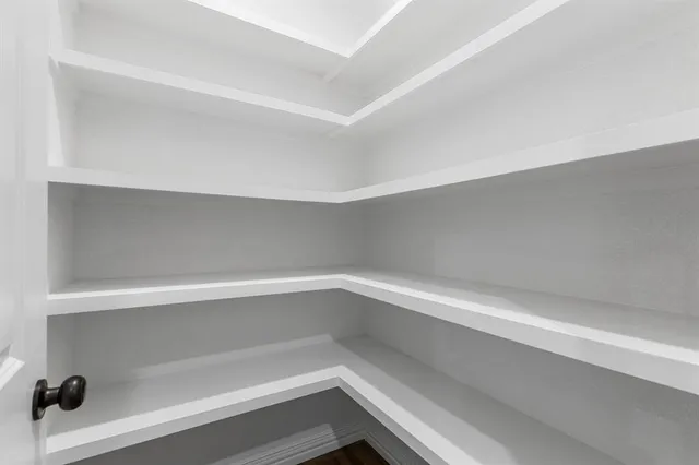 a view of a livingroom with a ceiling fan and window