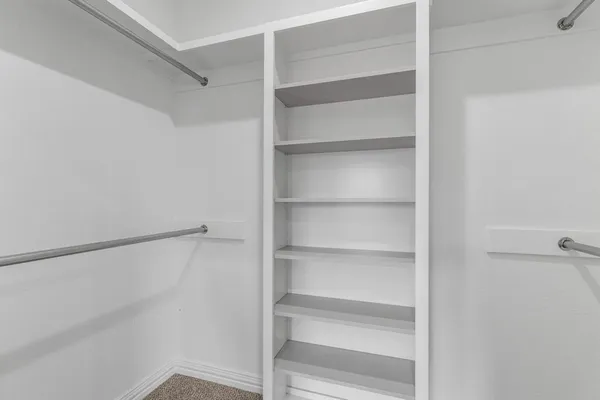 a spacious bathroom with a double vanity sink a mirror and a shower