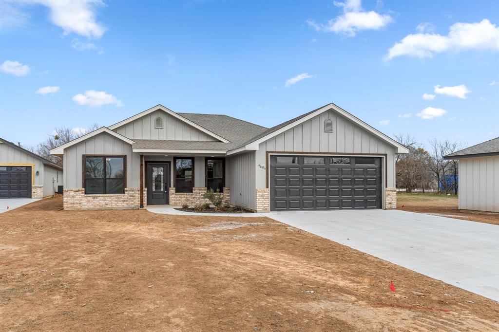 4695 Sisk Road Wichita Falls, TX 76310 - Photo 2 of 32 a front view of a house with a yard and garage