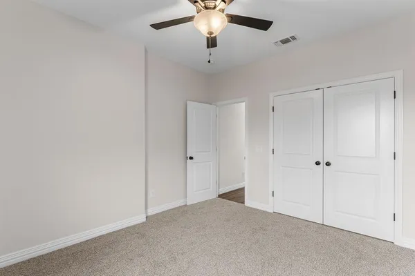 a big house with yard and a large tree