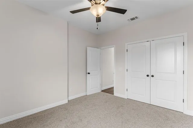 a big house with yard and a large tree