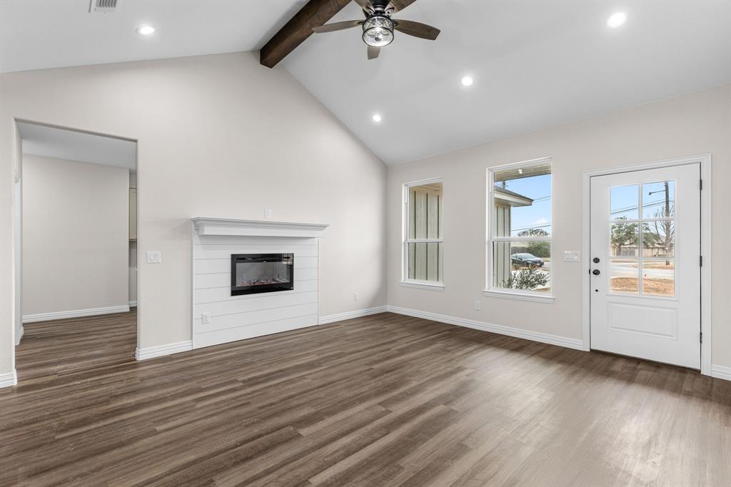 4695 Sisk Road Wichita Falls, TX 76310 - Photo 5 of 32 a view of an empty room with a window and wooden floor
