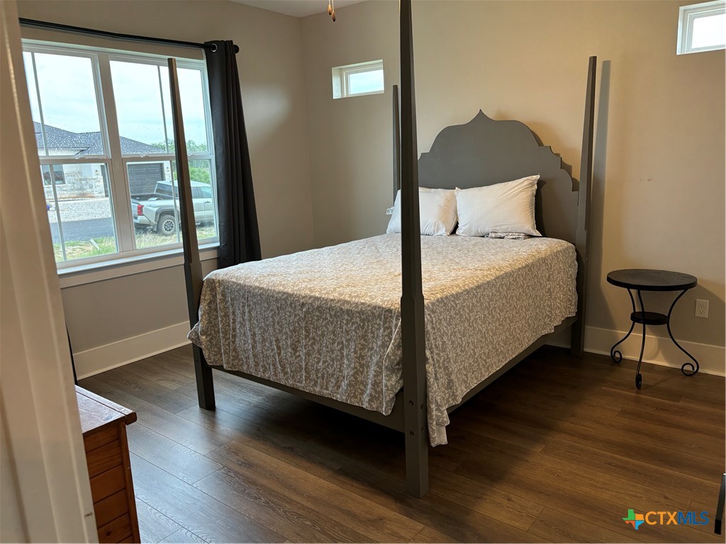110 Hiram Cook Blanco, TX 78606 - Photo 8 of 46 a bedroom with a bed and wooden floor