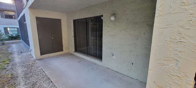 an empty room with closet and a hallway