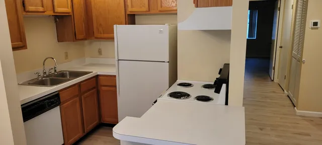 a kitchen with a refrigerator sink and stove