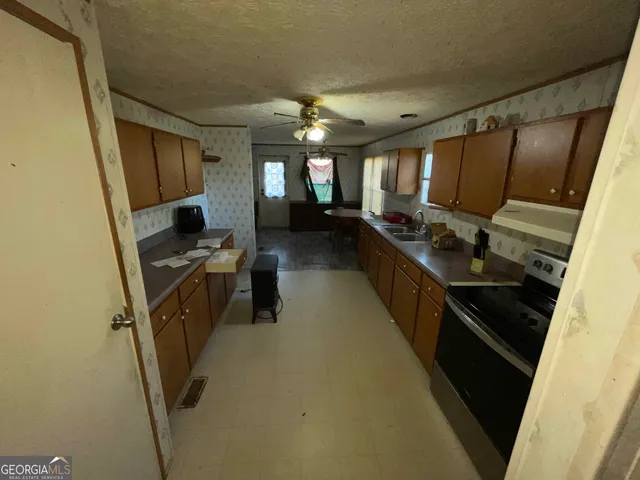 a kitchen with lots of counter top space and appliances