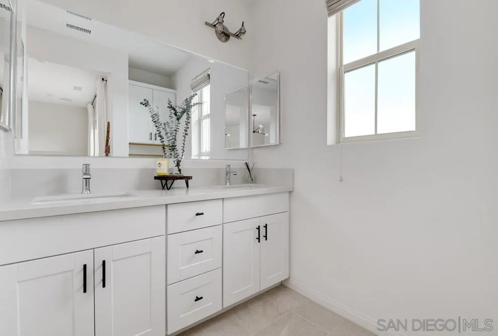 1643 Fig Tree Way Oceanside, CA 92056 - Photo 17 of 29 a bathroom with 2 sink and a mirror