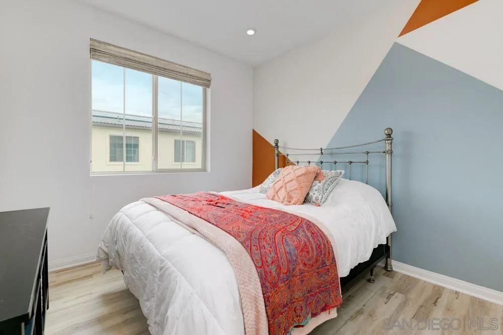 1643 Fig Tree Way Oceanside, CA 92056 - Photo 19 of 29 a bedroom with a bed and wooden floor