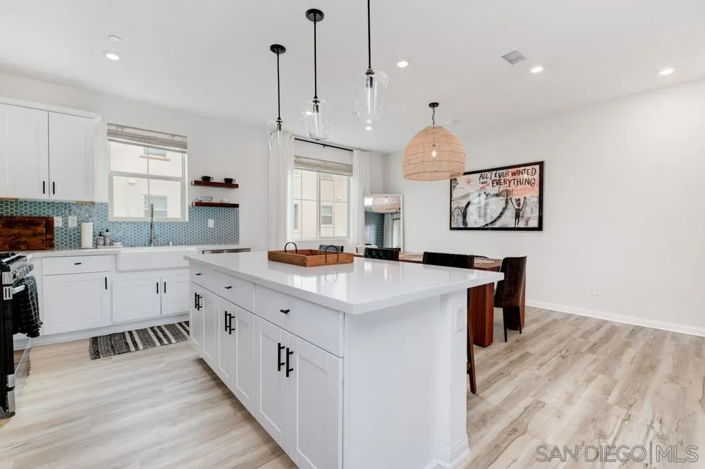 1643 Fig Tree Way Oceanside, CA 92056 - Photo 7 of 29 a kitchen with cabinets wooden floor and a clock