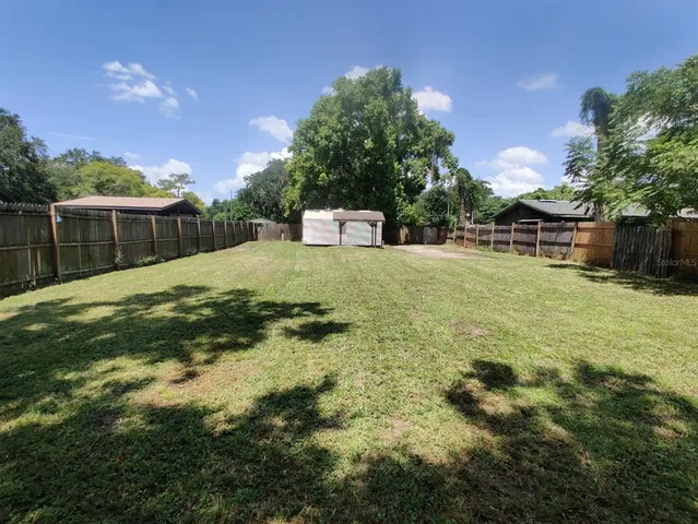 a backyard of a house with lots of green space