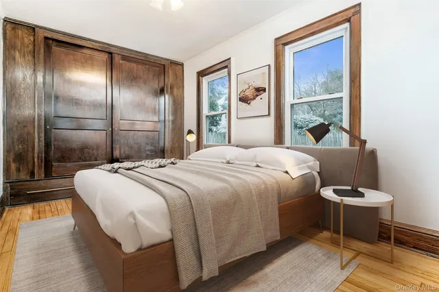 a bedroom with a bed and a painting on the wall