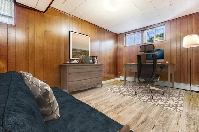 a living room with table chairs and a wooden floor