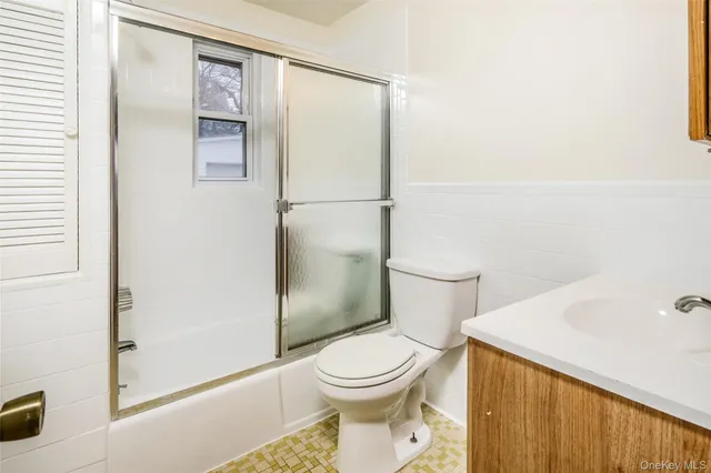 a white toilet sitting next to a bathroom sink