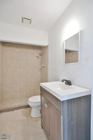 a bathroom with a sink a toilet and mirror