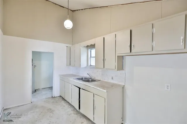 a kitchen with stainless steel appliances granite countertop white cabinets and white stove