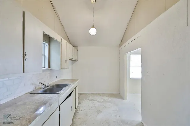 a kitchen with stainless steel appliances granite countertop a sink a stove and a granite counter tops