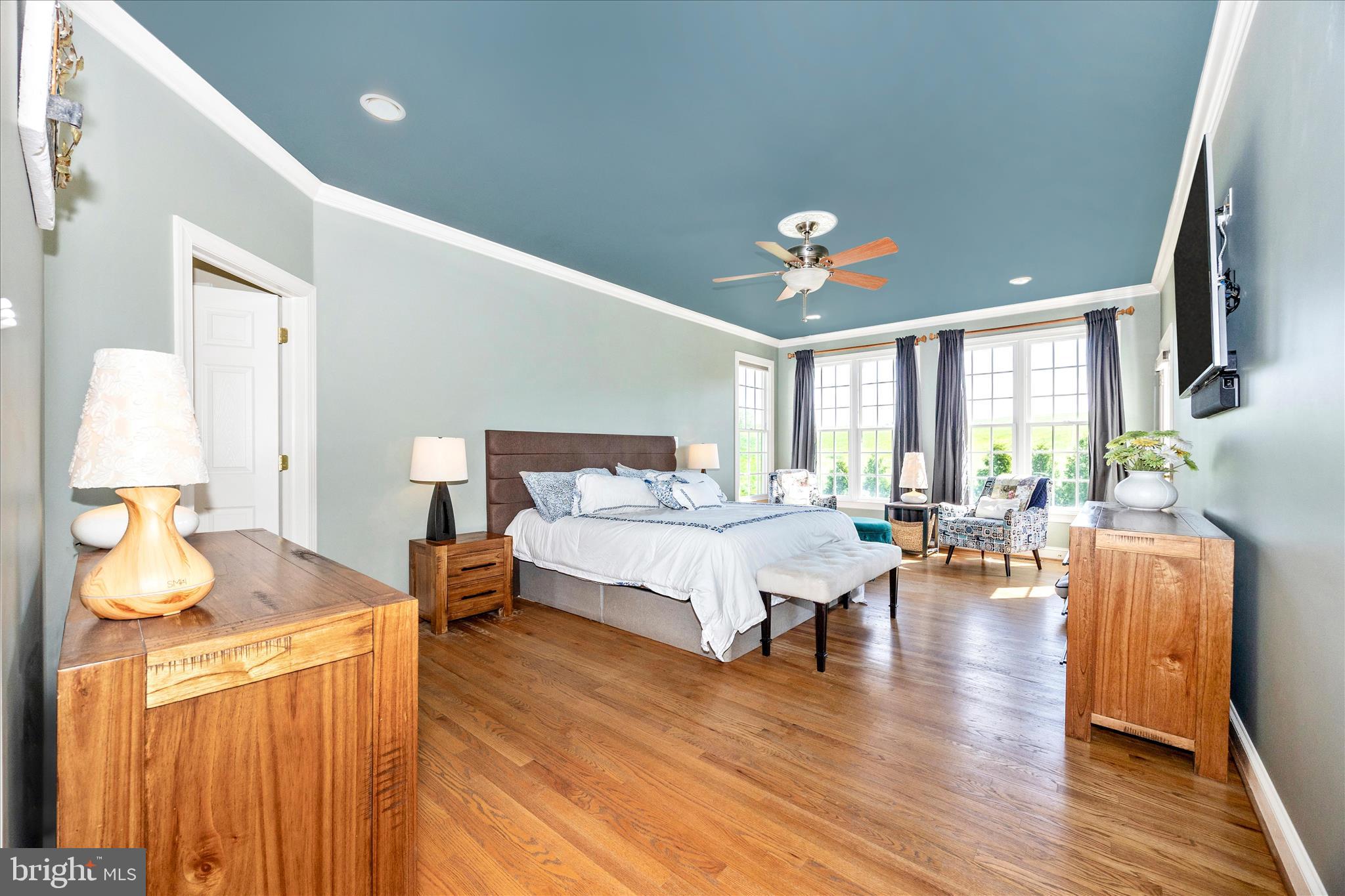 14746 New Windsor Road New Windsor, MD 21776 - Photo 22 of 67 a spacious bedroom with a bed and wooden floor