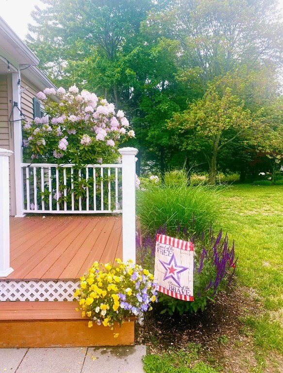 37 Beach Point Road Lancaster, MA 01523 - Photo 2 of 14 a view of a couple of flower garden with wooden fence