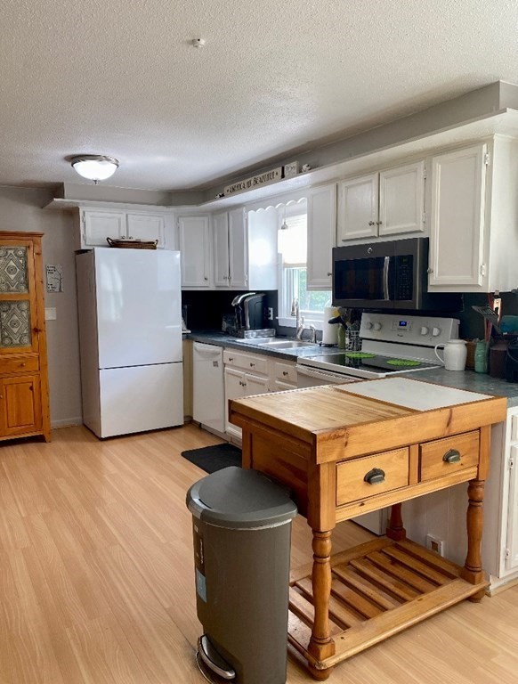 37 Beach Point Road Lancaster, MA 01523 - Photo 5 of 14 a kitchen with stainless steel appliances granite countertop a stove a sink dishwasher and a refrigerator