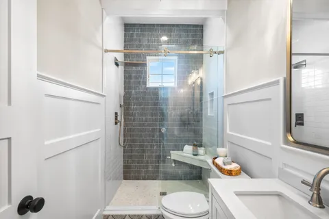 a bathroom with a sink toilet and shower