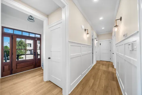 a view of a hallway with wooden floor