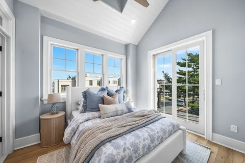 a bedroom with a large bed and a large window