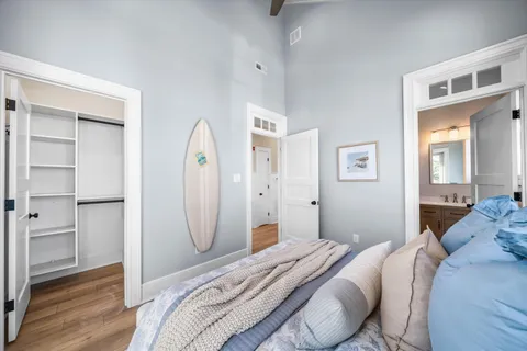 a bedroom with a bed and wooden floor