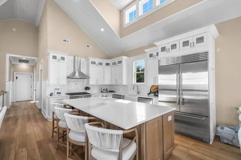 a kitchen with a center island appliances and cabinets