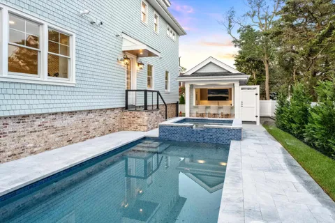 a view of a house with a small yard and wooden floor