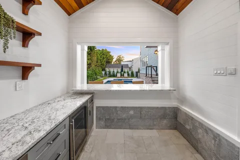 view of kitchen with granite countertop window