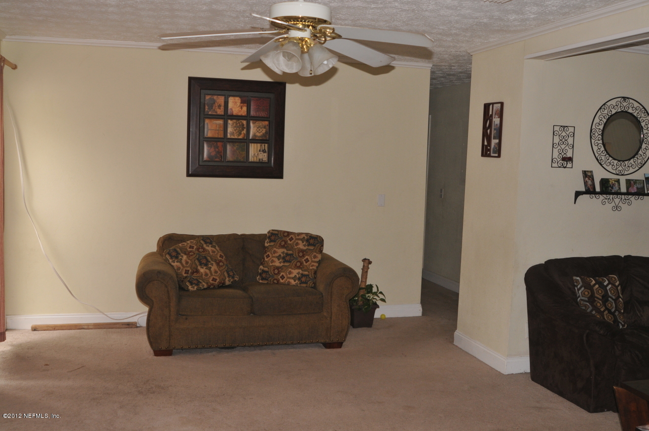 12945 Mandarin Road Jacksonville, FL 32223 - Photo 15 of 15 a living room with furniture flowerpot and a window