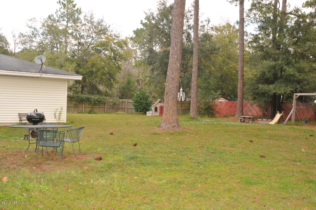 12945 Mandarin Road Jacksonville, FL 32223 - Photo 8 of 15 a backyard of a house with table and chairs
