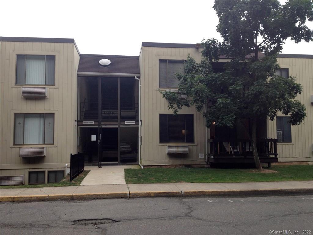 a front view of house with a garden