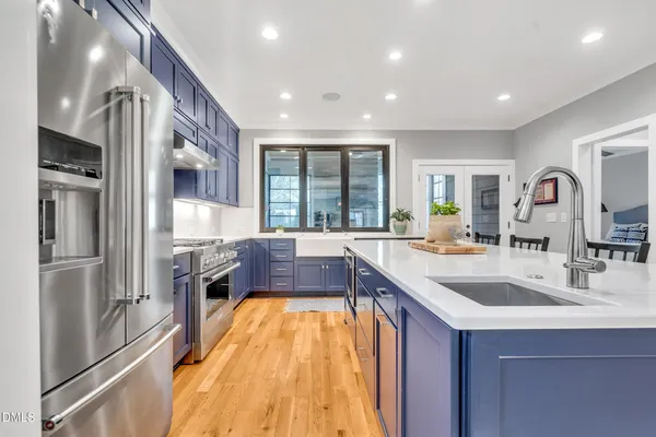 a en suite bathroom with a granite countertop sink and a mirror