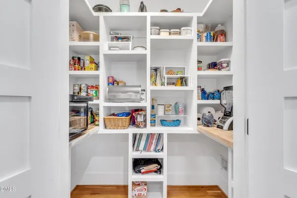 a kitchen with stainless steel appliances granite countertop a table chairs refrigerator and a sink