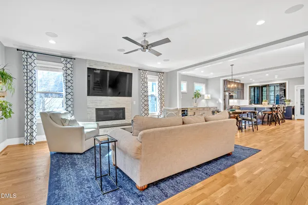 a living room with furniture a flat screen tv and a fireplace