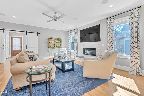 a view of a hallway with wooden floor and furniture