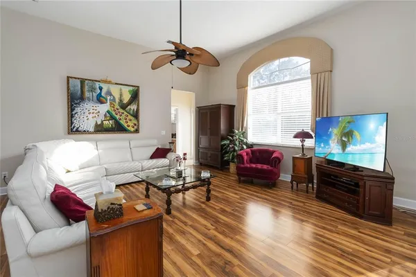 a living room with furniture a window and a flat screen tv