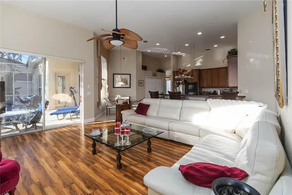 a living room with furniture and kitchen view