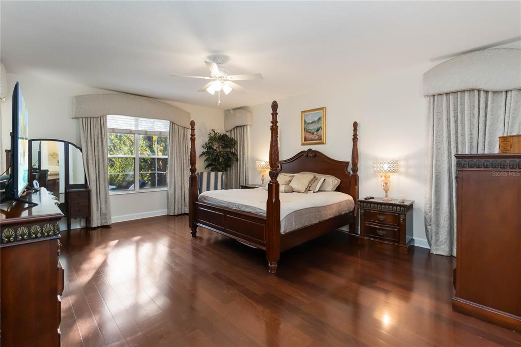 9138 Shadowbrook Trail Orlando, FL 32825 - Photo 14 of 47 a bedroom with a bed and wooden floor