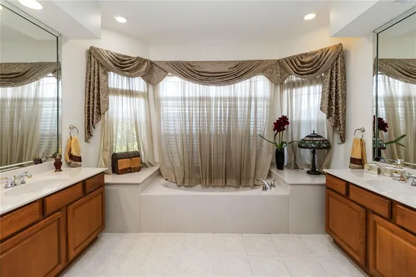 a bathroom with a double vanity sink mirror and shower