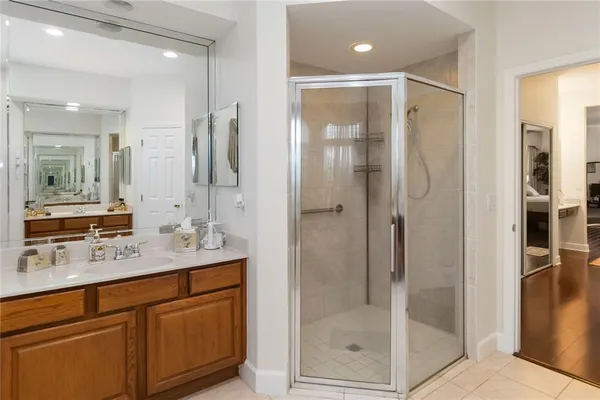 a bathroom with a shower sink and mirror