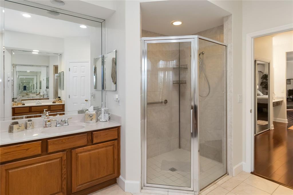 9138 Shadowbrook Trail Orlando, FL 32825 - Photo 17 of 47 a bathroom with a shower sink and mirror