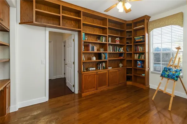 a view of a workspace with furniture and wooden floor